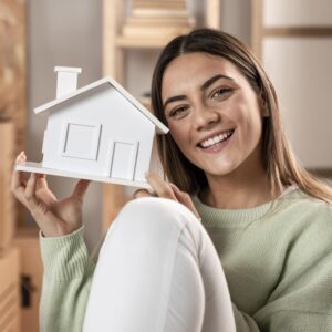medium-shot-woman-holding-small-house